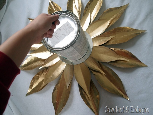 Put something heavy on your DIY Starburst Mirror while the glue is drying {Sawdust and Embryos}