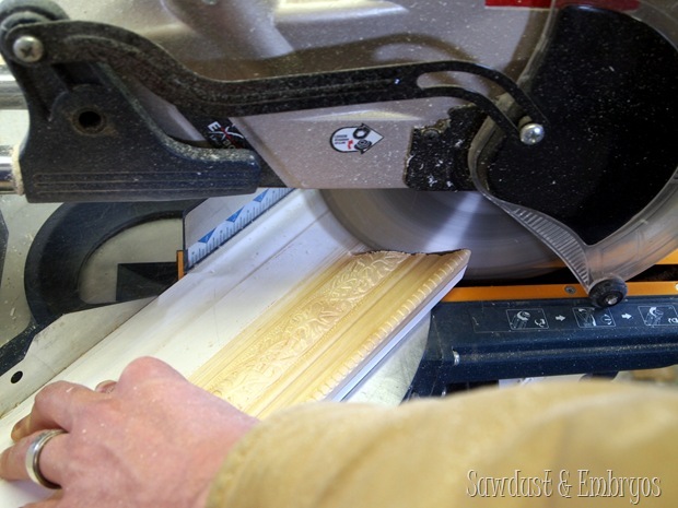 Using our compound miter saw, we cut at 45 degree angles for our corners.