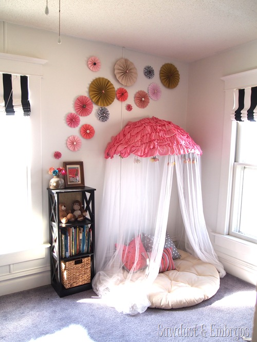 Adding a cute pinwheel collage to a room is an easy decoration addition for a kids room like over this cute reading nook