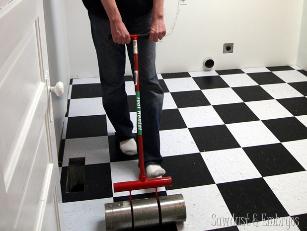 Using a tile roller on CVT flooring {Sawdust and Embryos}