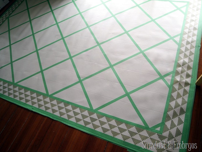 Tape a pattern to paint a remnant of linoleum to look like an area rug for under your dining room table! {Sawdust and Embryos}