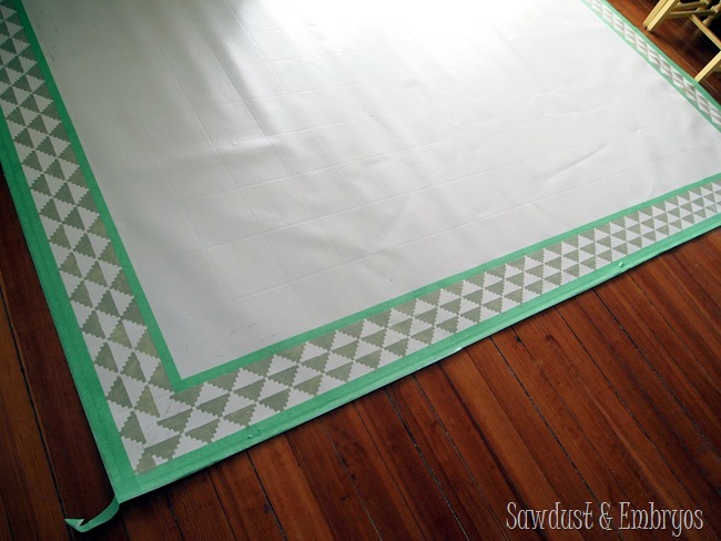 Painting a remnant of linoleum to act as an area rug for the dining room! 