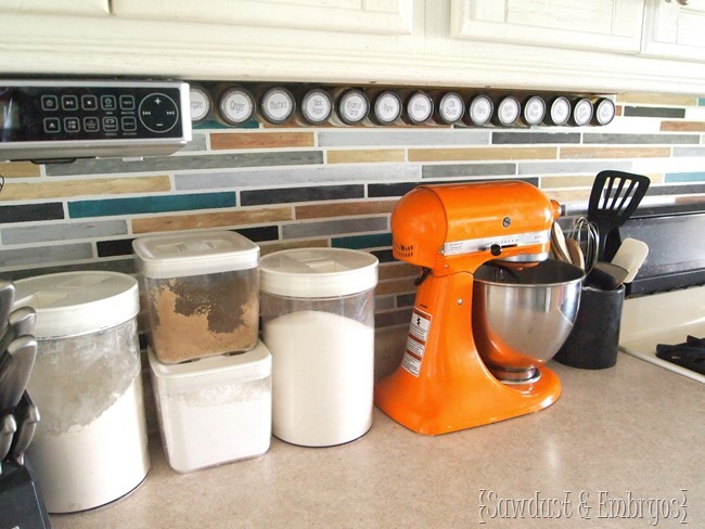 Affix spice jars under your cabinets using a velcro-like technology... genius! {Sawdust and Embryos}