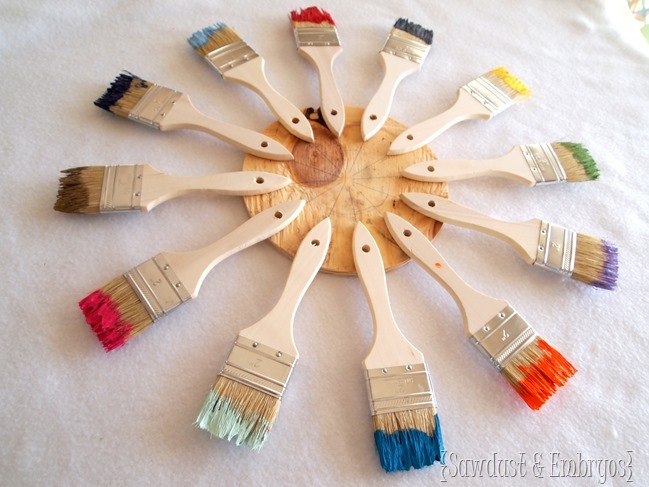 Use paint brushes dipped in different colored paints to create a unique starburst clock or mirror! {Sawdust and Embryos}