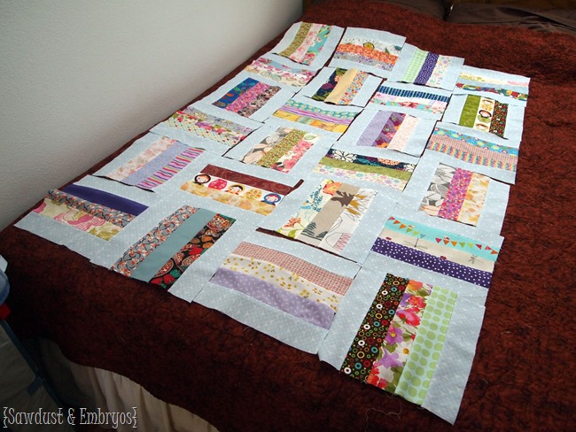 Piecing together a baby quilt made from sentimental scraps of fabric from friends and family members {Sawdust and Embryos}