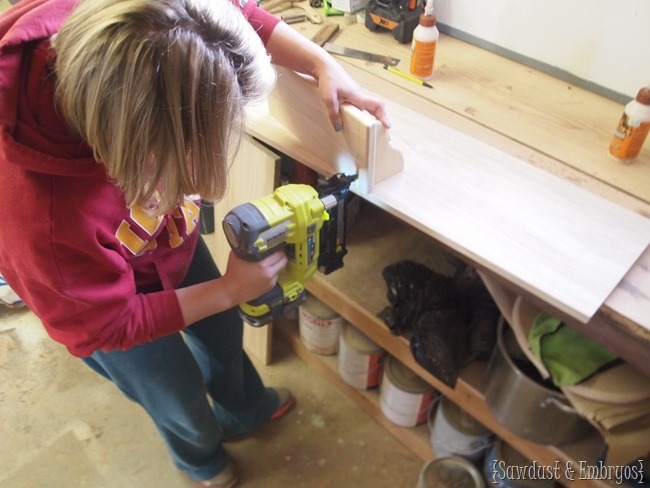 Make a laundry organizer to hold your ironing board, hanging clothes, and spare socks {Sawdust and Embryos}